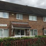 Conventional 50’s style brick shared house for people aged 16 and over, with a range of learning disabilities. Hosting disabled access and privacy from a mahogany picket fence and shrubbery.