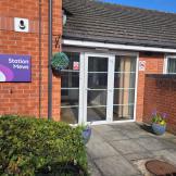 Red brick building with a glass fronted entrance