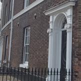 Exterior image of Merchant Terrace a dark bricked townhouse 